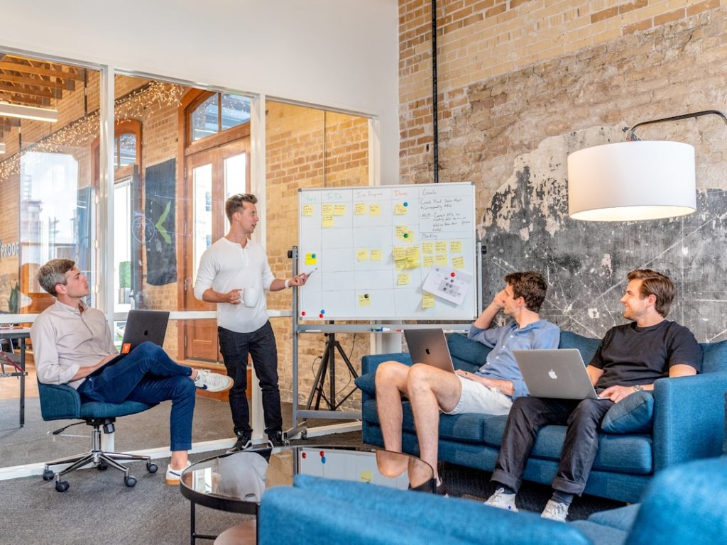 three-men-sitting-while-using-laptops-and-watching-man-beside-whiteboard-wd1lrb9oeeo three-men-sitting-while-using-laptops-and-watching-man-beside-whiteboard-wd1lrb9oeeo
